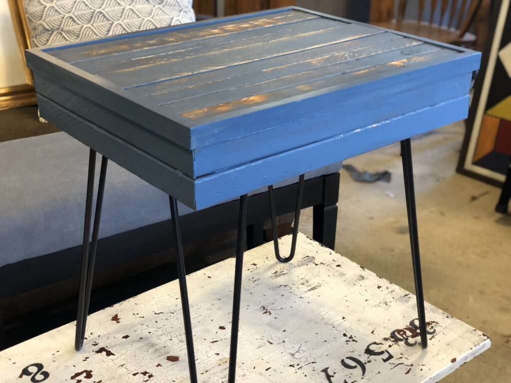 Finished wooden side table with hairpin legs.